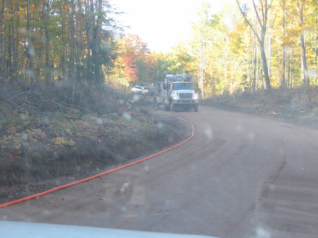 Contractors laying cable on AAA road to power mine facility