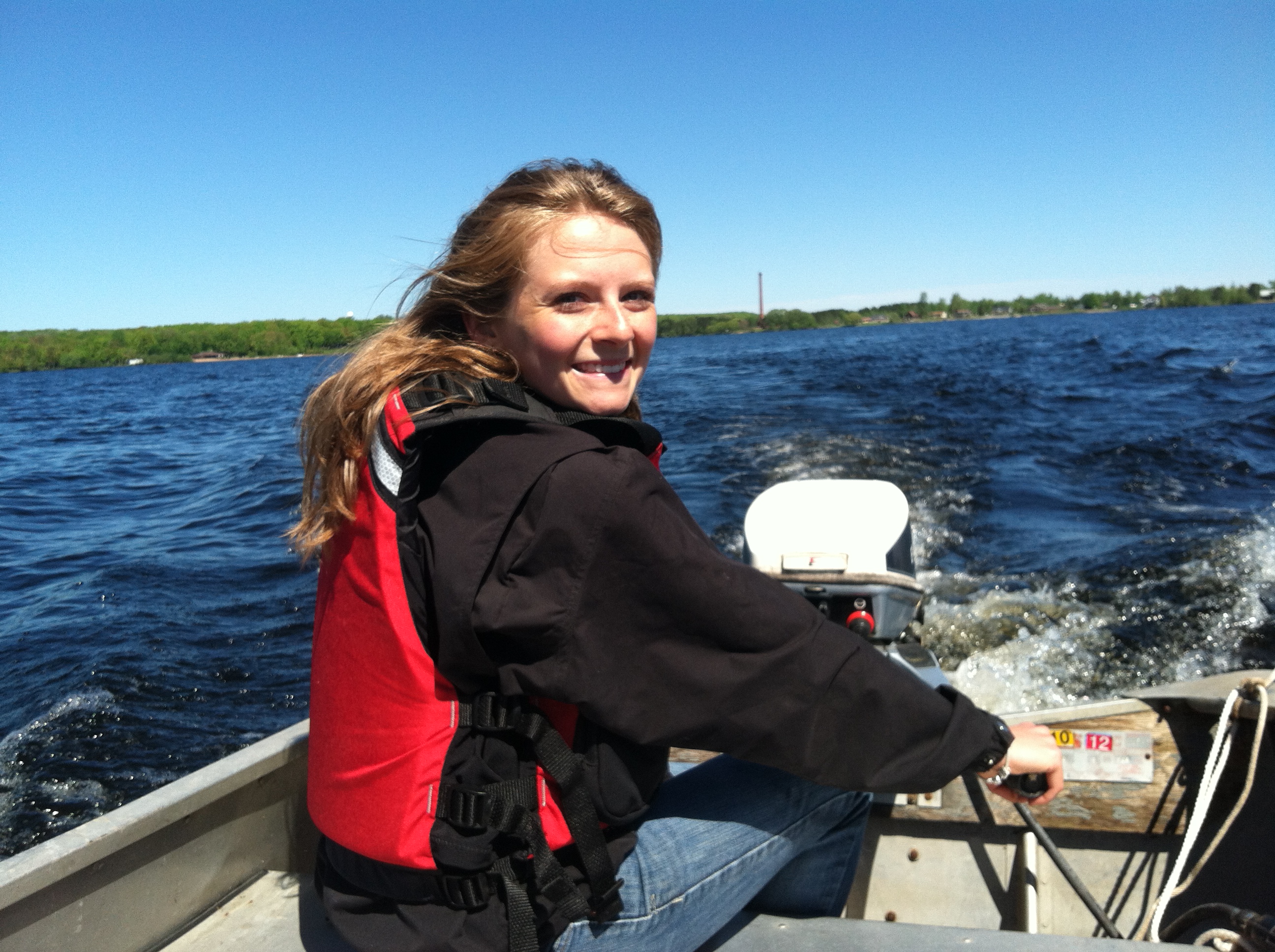 Volunteer leader Xavier Donajkowski steering the boat out onto Lake Independence to collect water quality information in 2014.