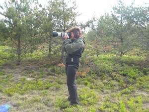 Nancy Moran checking out birds on the Yellow Dog Plains through her camera lens. Photo by Rochelle Dale