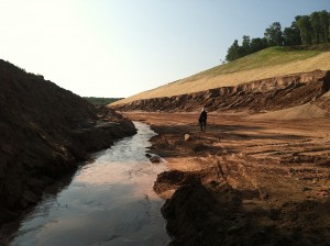 Spring water running through the construction site on the new County Road AAA, a haul road for Eagle Mine. A series of springs were ruptured during construction activities and led to the pollution of a wetland. Photo dated August 6, 2014 courtesy of Yellow Dog Watershed Preserv